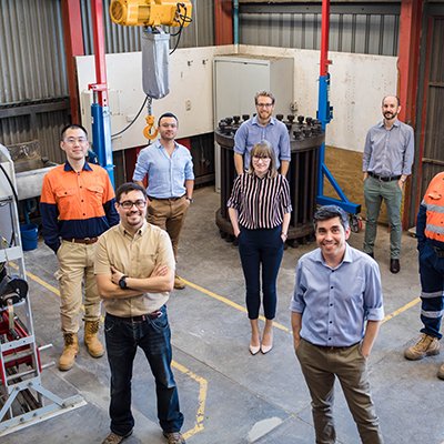 UQ blasting and fragmentation technology team standing socially distanced in a lab